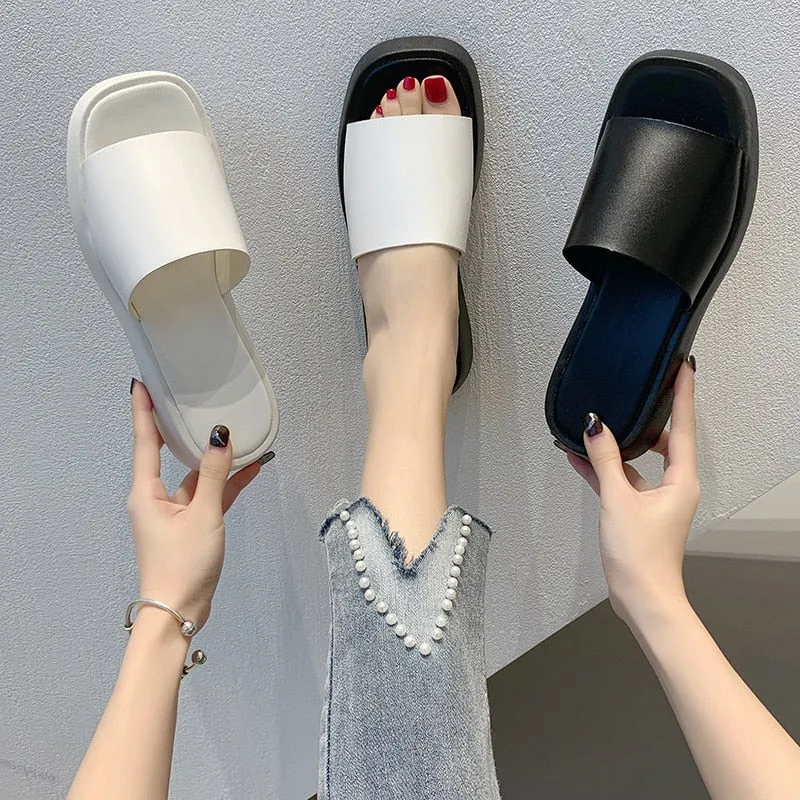 Minimalist slide sandals with a wide strap